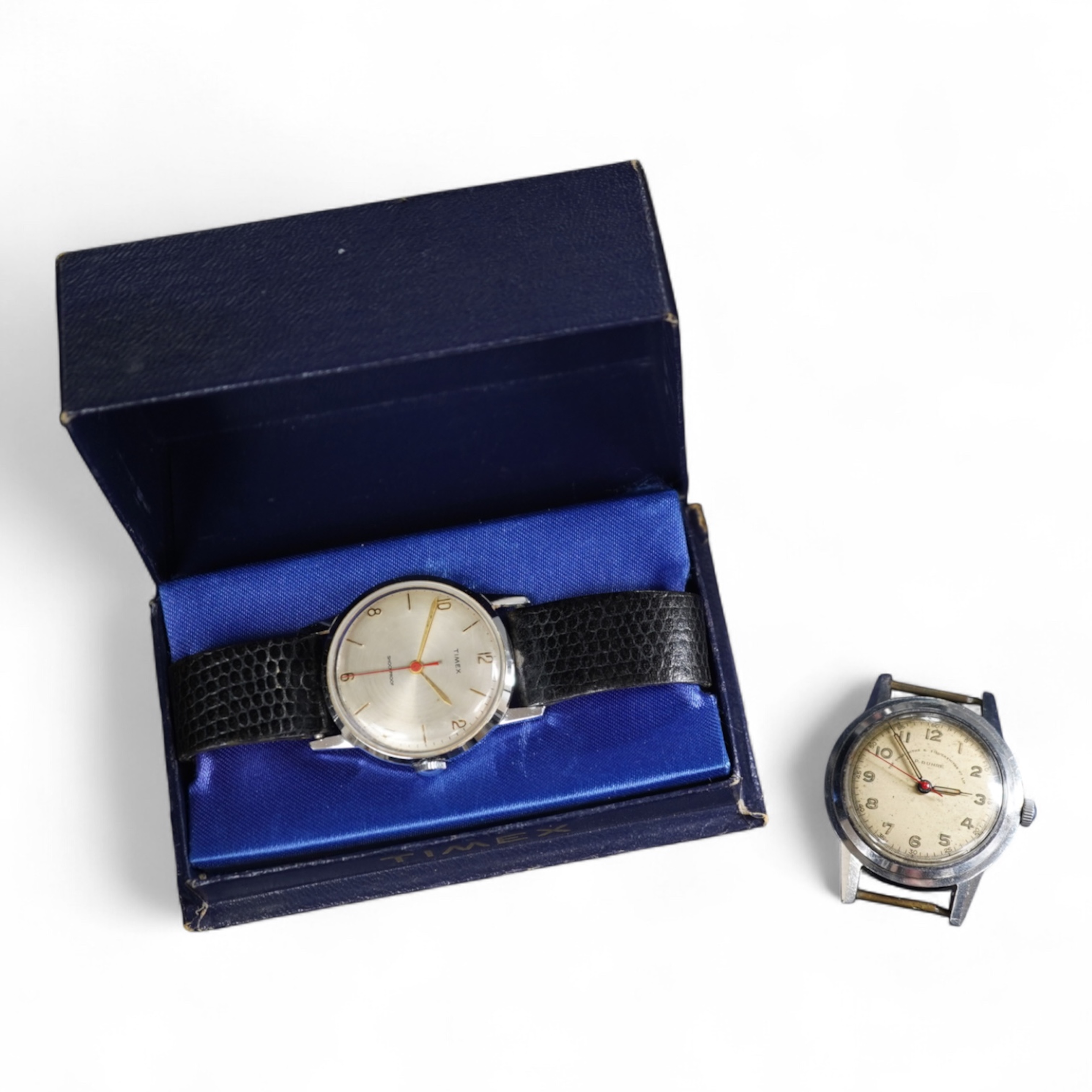 Two 1950s manual wind wrist watches; a gentleman’s stainless steel wristwatch by P. Buhre, retailed by the Goldsmiths & Silversmiths Company Ltd. case diameter 34mm, no strap, together with a Timex watch with box and pap